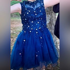 Dark blue prom dress. Zip back. Size 4. Sequin tops. Sheer bottom. Wore once.